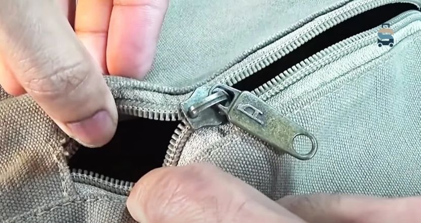 how to get zipper unstuck from fabric on backpack